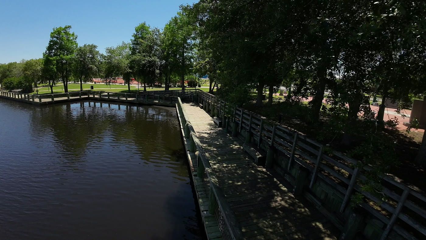 The downtown Moss Point riverfront boardwalk over the Escatawpa, with the riverside park beyond