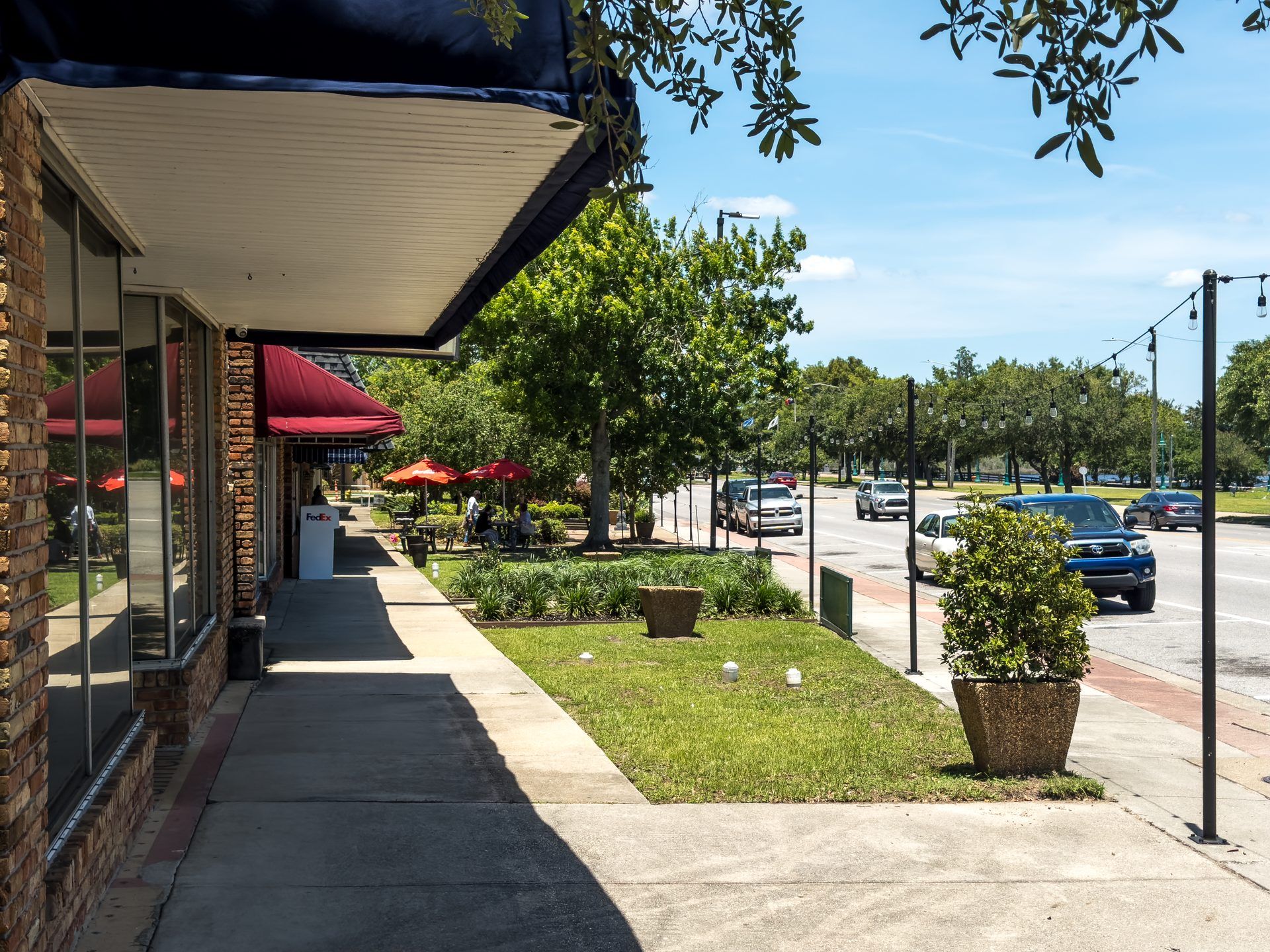 A downtown Moss Point Main Street block of brick storefronts with awnings and string lights
