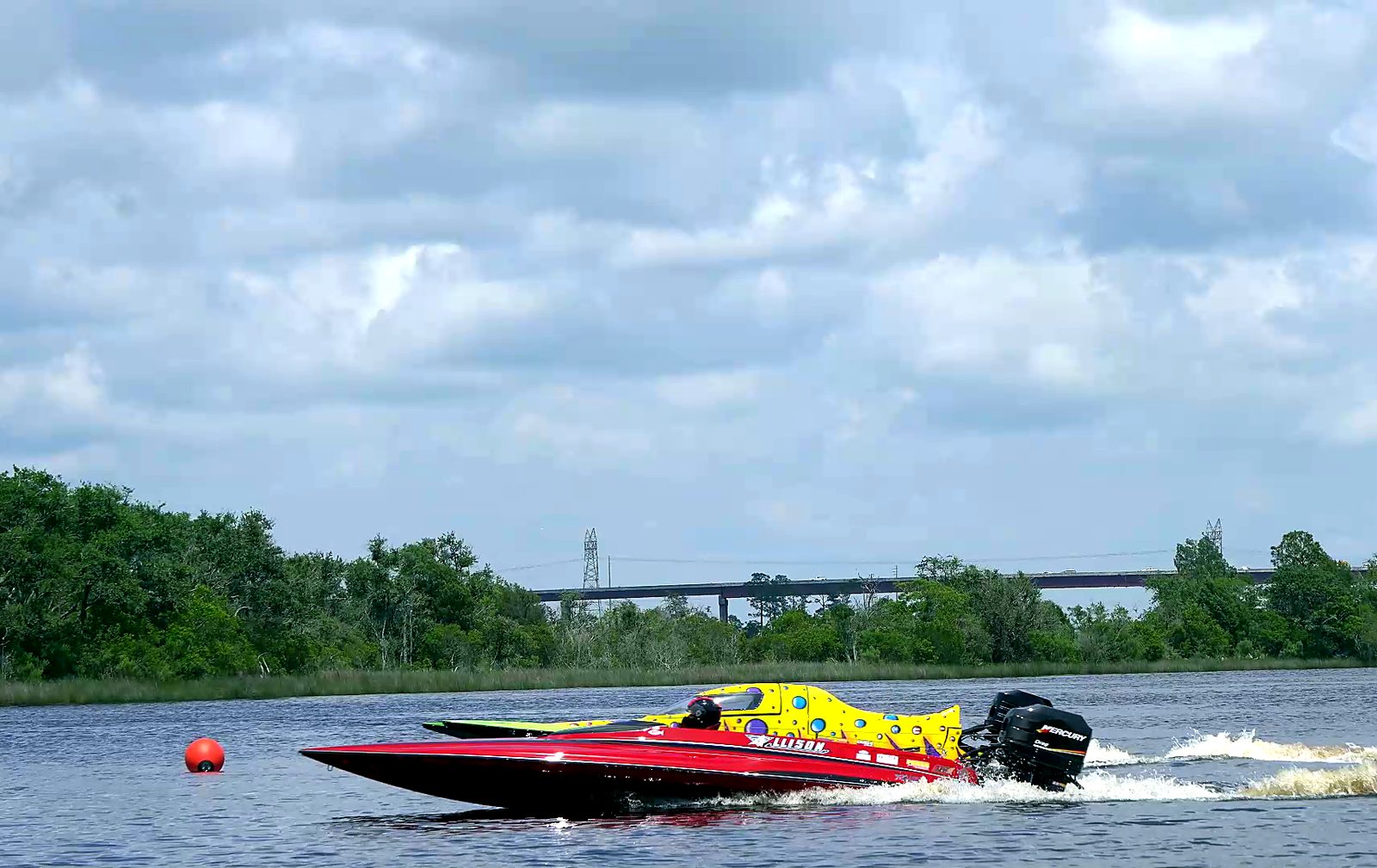 A red Allison drag boat leaning into launch beside a competitor on the Escatawpa