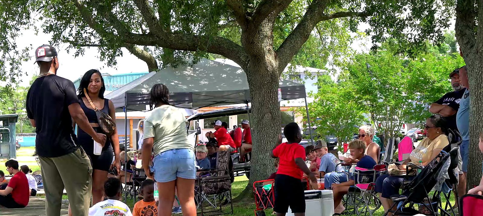 Spectators watching the races from the shade on the Moss Point riverfront