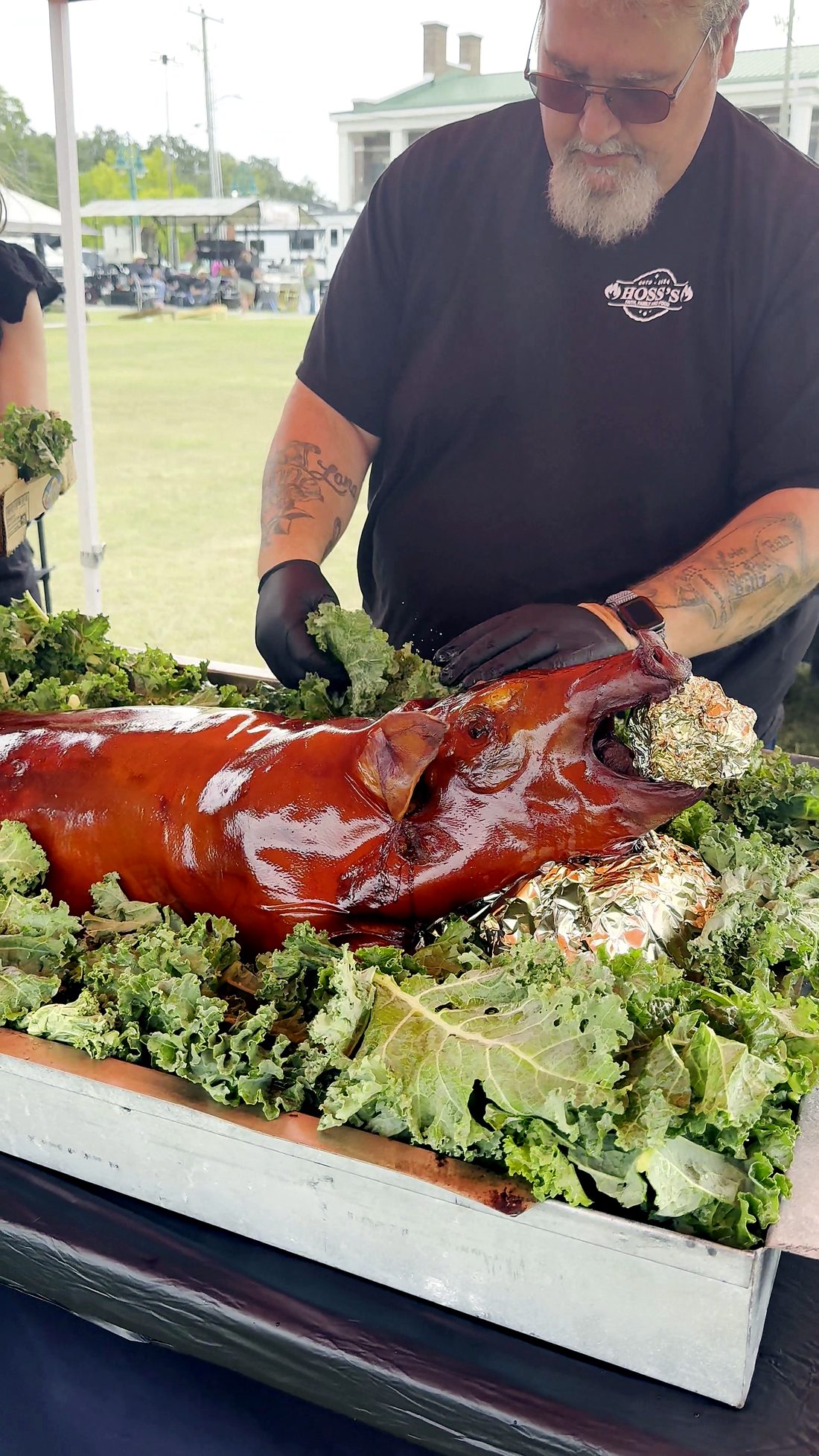 A pitmaster carving the whole hog