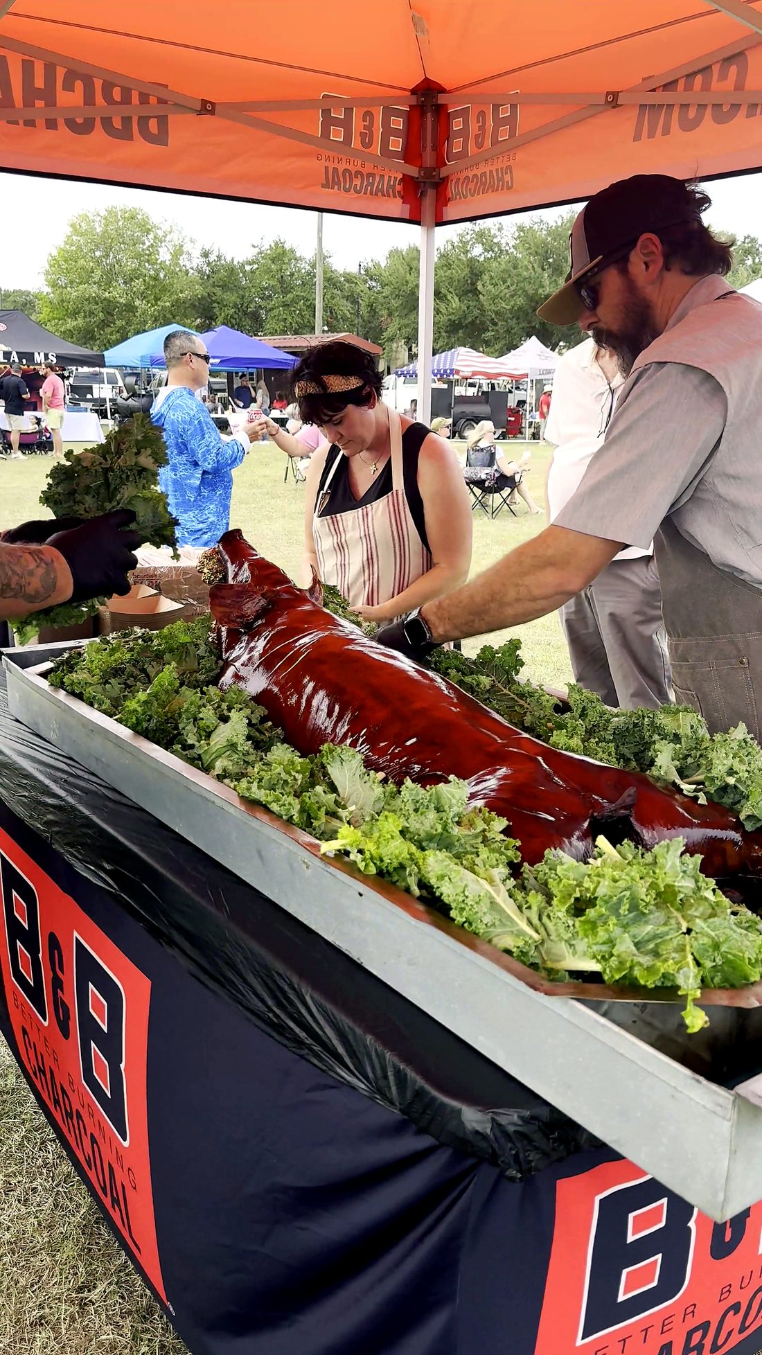 Serving barbecue samples under a vendor tent